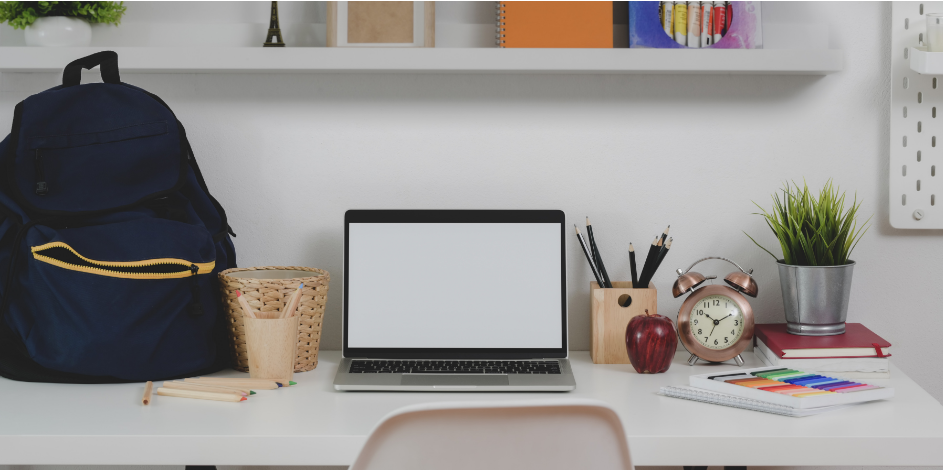  A desk with bookbag, computer, and pencils.